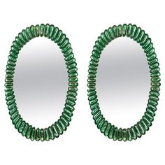 a pair of green beaded mirrors sitting next to each other