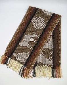 This beautiful Alpaca wool scarf is woven from Alpaca wool blend with llama and chakanas design. This scarf is originally made from local makers in Cusco - Peru. This beautiful scarf is a perfect cozy gift for your love one. Features: * Made from Alpaca and acrylic yarn. Measurements: 62 inches (L) x 9.5 inches (W) Dry clean or hand wash gently in cold water with mild detergent - dry flat - no machine dryer Brown Alpaca Shawl, Bohemian Brown Handwoven Scarves, Brown Bohemian Woven Scarf, Bohemian Brown Handwoven Scarf, Traditional Woven Winter Shawl, Bohemian Alpaca Scarves For Winter, One Size Handwoven Alpaca Shawl, Traditional Alpaca Shawl One Size, Bohemian Handwoven Alpaca Scarves