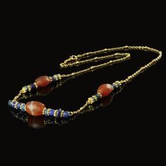 Roman Empire Necklace with Glass and Carnelian Beads 🏺✨ This exquisite necklace combines authentic Roman glass beads with beautifully faceted Carnelian stones, rethreaded with modern gold-plated spacers and a Jasseron chain for an elegant finish. The rich hues of blue glass and the fiery orange-red of Carnelian create a stunning contrast that captures the essence of Roman craftsmanship. Ancient Carnelian, a highly prized stone in the Greco-Roman era, was believed to possess magical properties, Ancient Roman Jewelry, Roman Jewelry, Roman Era, Empire Romain, Roman Soldiers, Roman Glass, Carnelian Stone, Carnelian Beads, Ancient Jewelry