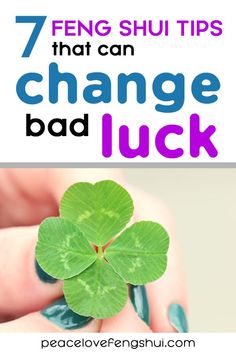 a person holding a four leaf clover with the text 7 feng shu tips that can change bad luck