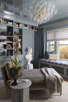 a living room with a couch, chair and book shelf