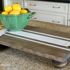 a wooden serving tray with lemons on it