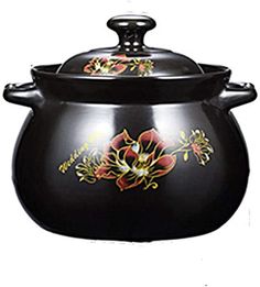 a large black pot with flowers painted on the side and lid is sitting in front of a white background