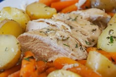 a white plate topped with meat, potatoes and carrots