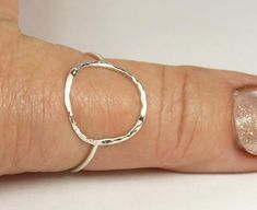 A hammered circle ring made with 18 gauge wire. Modern and simple minimal jewelry.Made with sterling silver Handmade and polished to a high shine in my shop.The circle symbol meaning is universal, sacred and divine. It represents the infinite nature of energy, and the inclusivity of the universe.Purity ring, karma ring,  midi ring modern and simpleIt's normal for sterling silver to change color to yellow or black due to oxidation after wear, just polish with warm water and a soft cloth, or use S Hammered Sterling Silver Midi Rings, Minimalist Hammered Sterling Silver Midi Rings, Silver Hammered Minimalist Midi Rings, Hand Forged Sterling Silver Stackable Rings, Silver Hammered Midi Rings, Karma Ring, Silver Jewelry Cleaner, Purity Ring, Circle Symbol