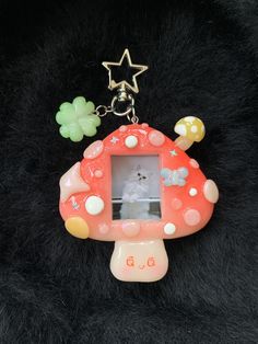 a keychain with a mushroom shaped photo frame attached to it