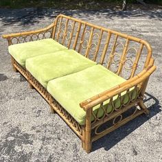 a wooden bench with green cushions on it