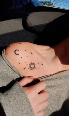 a woman's chest with stars and the moon on it