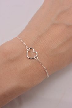 REAL STERLING SILVER - A QUALITY PIECE This is an original design by The Violet Goat. I make this beautiful bracelet using a sterling silver heart charm set on sturdy sterling silver chain (all 925 sterling). Secures with a lobster clasp and comes in a gift box. These make great group gifts. Heart measures approximately 1/2 inch. FEATURED ON WOMAN'S DAY WEBSITE: This little beauty had the honor of being featured on several different sites, including a gift guide article for Woman's Day. This ori Minimalist Open Heart Bracelet As Gift, Minimalist Sterling Silver Heart Bracelet For Mother's Day, Sterling Silver Double Heart Bracelet For Everyday Wear, Adjustable Delicate Sterling Silver Heart Bracelet, Minimalist Silver Double Heart Bracelets, Everyday Sterling Silver Double Heart Bracelet, Everyday Double Heart Sterling Silver Bracelet, Sterling Silver Heart Bracelet For Everyday, Sterling Silver Heart Pendant Bracelet For Valentine's Day