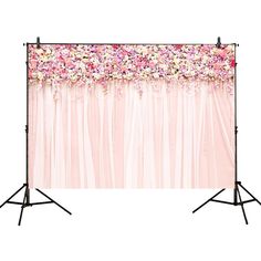 an image of a backdrop with pink flowers on the side and white curtains behind it