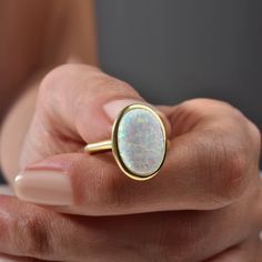 Opal Ring, Vintage Opal Ring, Minimalist Ring, Mother's Day Gift, October Birthstone Ring, Stacking Ring, Gift For Her Elevate any look with our Vintage Opal Ring. This minimalist piece exudes timeless charm, making it a perfect gift for Mother's Day or October birthdays. Crafted with care, its iridescent opal centerpiece adds a touch of elegance to any outfit. Stack it or wear it solo for understated luxury. A beautiful minimalist piece to have in ones collection 🎀 Free Returns and Money-back White Oval Cabochon Ring As Gift, White Oval Cabochon Ring For Gift, White Oval Cabochon Promise Ring, Opal Birthstone Ring Oval Cabochon For Anniversary, Opal Birthstone Ring With Oval Cabochon For Anniversary, Oval Cabochon Opal Ring For Anniversary, Yellow Gold Opal Ring Oval Cabochon For Gift, Oval Cabochon Opal Birthstone Ring For Anniversary, Fine Jewelry Oval Stackable Rings As Gift