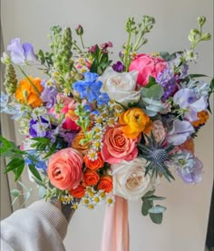 a person holding a bouquet of flowers in their hand