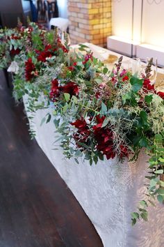 flowers and greenery are lined up on a table