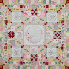 a colorful quilt with hearts and flowers on it