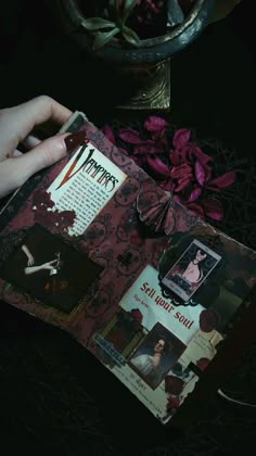 a person is holding an open book with pictures on it and flowers in the background