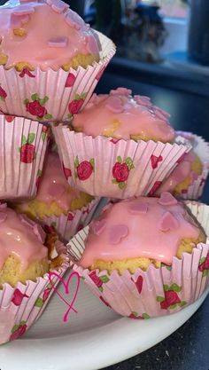 there are many pink cupcakes on the plate