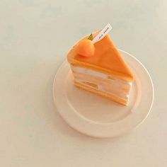 a piece of cake sitting on top of a white plate next to an orange slice