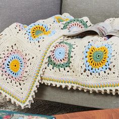 a crocheted blanket sitting on top of a couch