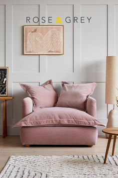 a living room with a pink couch and rug