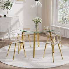 a round glass table with gold legs and clear chairs in front of a white rug