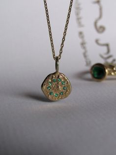 Gold Jewelry With Coin Pendant For May Birthstone, Dainty Gold Emerald Round Necklace, 14k Gold Gemstone Flower Pendant Jewelry, Gold Dainty Emerald Necklace, Gold Plated Fine Jewelry Birthstone Pendant Necklace, Gold Plated Birthstone Pendant Necklace, Gold Plated Pendant Birthstone Necklace, Gold Plated Round Emerald Necklace, Round Gold Plated Emerald Necklace