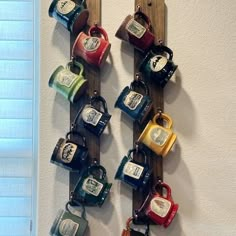 there are many mugs hanging from the hooks on this coat rack, which is made out of wood