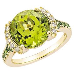 a ring with an oval cut green stone surrounded by small white and yellow diamond accents