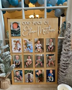 a baby's first year calendar is displayed in front of a window with balloons