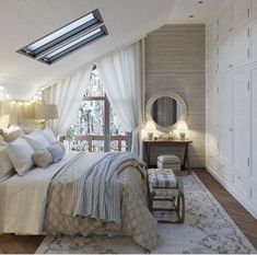 a bedroom with a large bed and lots of pillows