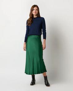 A fluid, midi-length slip skirt made of silky, sheeny charmeuse. The fabric is cut on the bias (diagonally,) which gives it an extra-flattering drape that hugs — but doesn't cling to — your hips and waist. It's got a covered elastic waist that just pulls on, and it looks just as great with a t-shirt as it does with a silk blouse (or the matching top!)