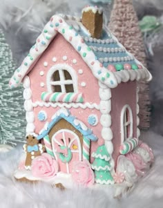 there is a pink gingerbread house on display