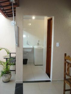 an open door leading to a bathroom with a sink and toilet