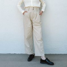 The Kate Pants Are A Wear-Anywhere Style. The Pleats Add A Tailored Touch While Maintaining Comfort And The Double Buttons Add Interest To The Waistline. Double Button, Elastic Back, Pleats, Functional Pockets, Belt Loops Pair With Lena Shirt And Loafers For Work Or Wear It Casually With A Fitted Tank, Baseball Cap, And Chunky Sneakers. Measurements: S/ Waist: 12-13.5" Stretched, Hip: 20", Rise: 13", Length: 26" M/ Waist: 13-15" Stretched, Hip: 20", Rise: 13", Length: 26" L/ Waist: 14-16" Stretc Ankle-length Business Casual Pants With Buttons, High Waist Pants With Button Closure For Business Casual, Spring Business Casual Work Pants With Button Closure, Spring Work Pants With Button Closure And Tapered Leg, Spring Tapered Leg Work Pants With Button Closure, Spring Tapered Leg Work Pants, Classic Bottoms With Buttons For Fall, Business Casual High-waisted Pants With Buttons, Classic Buttoned Bottoms For Fall