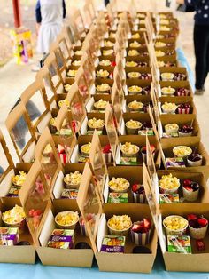 many boxes of food are lined up on a table