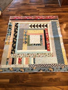 a patchwork quilt is on the floor