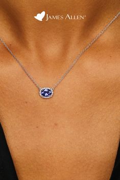 Celebrate a classic look with this necklace featuring an east-west set tanzanite oval surrounded by a halo of diamonds and a signature clasp for a perfect adjustable fit | James Allen Necklace Style: 8340727W14 | #diamondpendant #diamond #diamonds #diamondjewelry #diamondnecklace #diamondring #jewelry #diamondearrings #jewellery #pendant #diamondjewellery #finejewelry #jewellerydesign #whitegold #fashion #gemstone #jamesallen Diamond Halo Necklace, Engagement Rings And Wedding Band, Necklace With Name, Bold Statement Jewelry, Tanzanite Pendant, Jewellery Pendant, Tanzanite Necklace, Diamond Necklace Designs, Halo Necklace