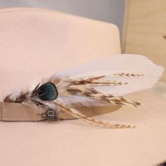 a white hat with feathers on top of it