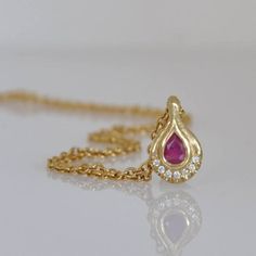 18k Gold Pendant with Ruby and Diamonds #diamondnecklace #GoldandRubynecklace #18kgoldnecklace #Handmadegoldjewelry Pear-shaped Gemstone Drop Necklace In Yellow Gold, Yellow Gold Pear-shaped Gemstone Drop Necklace, Gold Teardrop Necklace With Gemstone Accents, Yellow Gold Teardrop Jewelry With Bezel Setting, Yellow Gold Teardrop Gemstone Drop Necklace, Teardrop Ruby Necklace In Yellow Gold, Yellow Gold Ruby Teardrop Necklace, Yellow Gold Teardrop Ruby Necklace, Gold Teardrop Pendant Necklace With Gemstone Accents