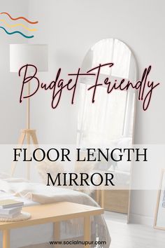 a bed room with a mirror and a lamp on the floor next to an arched window