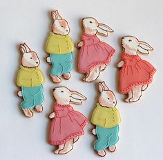 some cookies are shaped like rabbits wearing clothes