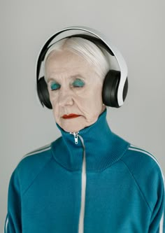 an old woman with headphones on her ears