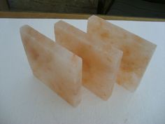 three pieces of soap sitting on top of a counter