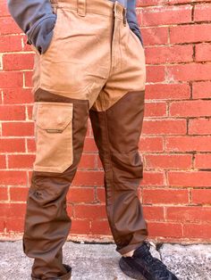 "Cargo pants, also sometimes called combat pants are loosely cut pants originally designed for rough work environments and outdoor activities, distinguished by numerous large utility pockets. Made of hard wearing fabric and ruggedly stitched, these are pants for all seasons and all activities Great for trekkers and hikers or for working outdoors in rain, wind, sun and shine As we say in Australia \"hard yakka\" - these epitomise hard yakka pants 🍺 Jack is 180cm tall with a 30 inch waist   🇦🇺 🦘 Our vintage items reflect the style and trends of the 80s/90s and earlier eras. They are second-hand pieces and thus have been stored for some time, previously worn and owned.   They can be up to 30 years old. Because of this the item may arrive with signs of minor wear and tear, fading, marks, e Full-length Parachute Pants With Patch Pockets For Workwear, Military Style Parachute Pants With Cargo Pockets For Outdoor, Outdoor Full-length Parachute Pants With Cargo Pockets, Military Style Outdoor Bottoms With Cargo Pockets, Knee Cap, Military Nylon Outdoor Pants, Combat Pants, 30 Years Old, Cargo Pants