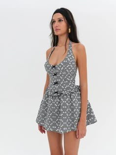 Warm up the Vespa, because we've got the perfect summer dress to zip around in. The Janice black halter dress is crafted in a ditsy gingham fabric—it features a fitted bodice with a mini, gathered skirt. Fit Notes The Janice Halter Mini Dress is fitted through the waist and flares out at the skirt. We recommend taking your usual size. Style Notes Fully lined Decorative satin bows at the center-front bodice Adjustable halter Smocked back bodice Fabric + Care Crafted in 98% polyester, 2% spandex Lining is made of 100% cotton Eco dry clean is recommended to avoid harmful chemicals like "perc" Gingham Mini Dress, 50s Pinup, Morgan Dress, Mini Dress Outfit, Black Gingham, Black Halter Dress, Dress Sketches, Gingham Fabric, Strapless Midi Dress