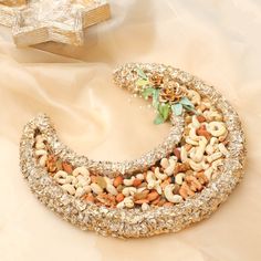 a necklace made out of nuts and other things on a white cloth with a star in the background