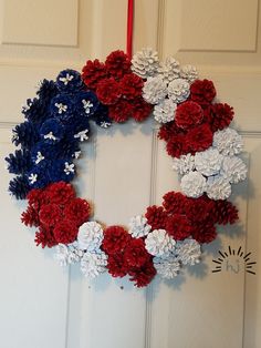 a wreath made out of red, white and blue flowers