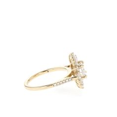 a yellow gold ring with an oval cut diamond set in the center and side stones