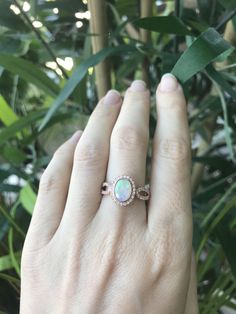 "An oval-shaped natural and genuine Opal set in a bezel setting accented with petite white sapphires handcrafted in your choice of 10k/14k/18k Rose/Yellow Gold or White Gold. This ring makes a lovely engagement/promise/October birthstone/statement ring. Wrapped in a Box ready for gift giving.(r-egt-20) Please note each opal has a unique play of color, if you wish for a certain color in the fire, please let us know and we will try to accommodate your request. View our Instagram video of this Ring Oval Diamond White Jewelry With Birthstone, Diamond White Oval Jewelry With Birthstone, Oval Opal Ring For Anniversary, Oval Cabochon Opal Ring With Accent Stones For Anniversary, Opal Birthstone Ring With Oval Cabochon For Anniversary, Opal Birthstone Ring Oval Cabochon For Anniversary, Oval Opal Birthstone Ring Fine Jewelry, Oval Cabochon Opal Birthstone Ring For Anniversary, Oval Cabochon Opal Ring For Anniversary