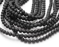 Ultra-polished and tumbled, matte black onyx beads are stylish and timeless. Utilize matte black onyx rounds in your next design to create a go-to piece. Beaders love our black onyx beads because of their great color, polish, and consistency. Black Onyx is never going out of style! Use these beads in practically any design - they always look great. Nearly all beads referred to as “black onyx” on the market today, including ours, are color enhanced. This centuries-old process creates a permanent, Black Onyx Round Beads, Black Onyx Gemstone Beads, Black Onyx 8mm Beads, Black Onyx Beads, Beads Online, Bead Store, Onyx Bead, Black Onyx, Czech Glass