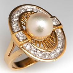 This radiant ring features an oval shaped gallery accented with one (1)  saltwater Akoya pearl, and a halo of twenty (20) bead set round brilliant cut diamond accents. The ring measures 21.6mm at the top, rises 10.7mm above the finger, tapering to 3.0mm wide and 1.0mm thick at the base of the shank.   It is crafted in 18k yellow gold and is currently a size 4.75.  The ring matches perfectly with the earrings under sku ab73326. Elegant Oval Brilliant Cut Pearl Ring, Elegant Oval Pearl Ring With Brilliant Cut, Elegant Oval Pearl Ring With Diamond Accents, Formal Akoya Pearl Oval Rings, Formal Oval Akoya Pearl Rings, Oval Akoya Pearl Rings For Formal Occasions, Classic Oval Pearl Ring With Diamond Accents, Timeless Oval Pearl Ring With Brilliant Cut, Classic Oval Pearl Ring With Center Stone